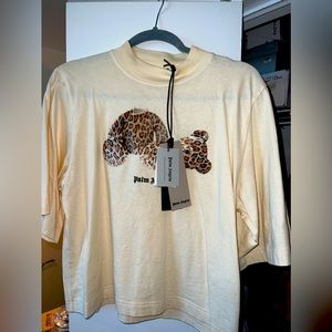 Palm Angels Cropped T-Shirt in Cream With Bear Graphic & Logo Printed At Front.